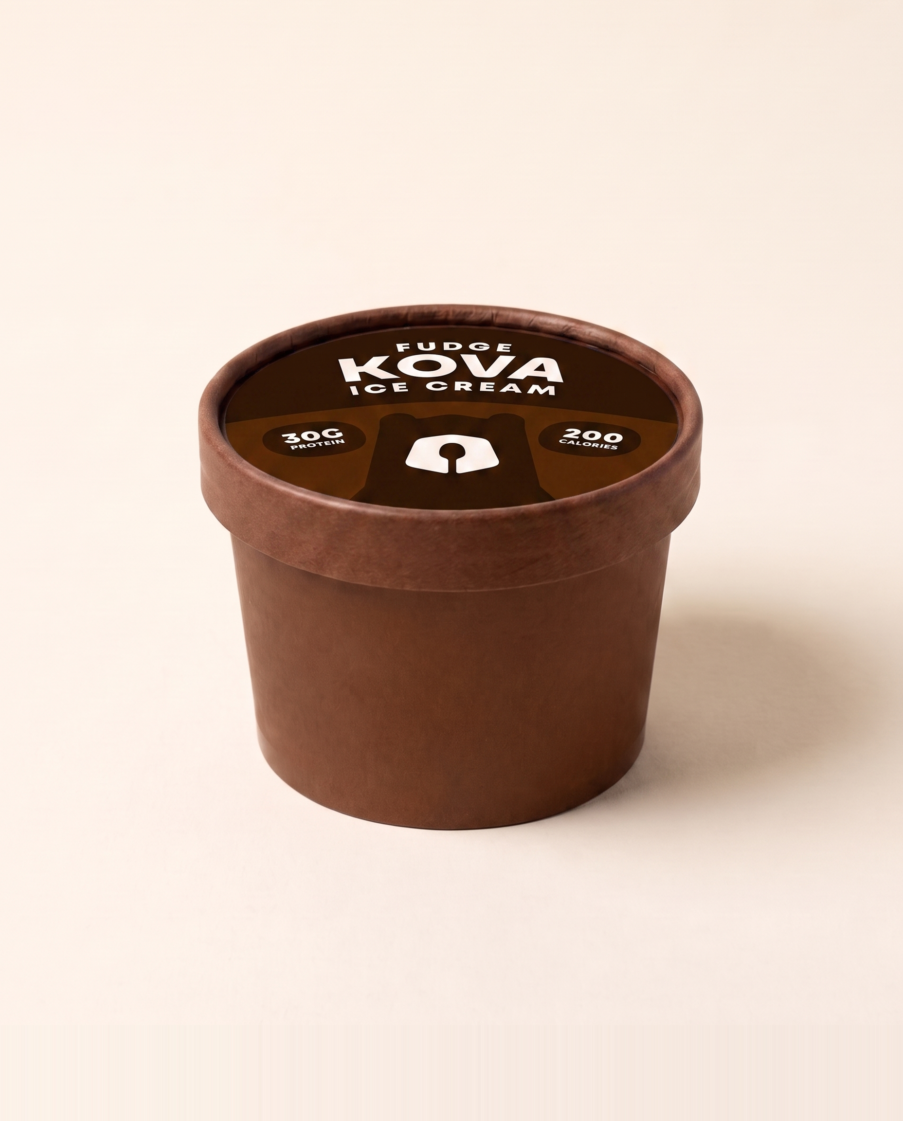 A single-serve cup of Kova fudge protein ice cream facing forward on a cream background