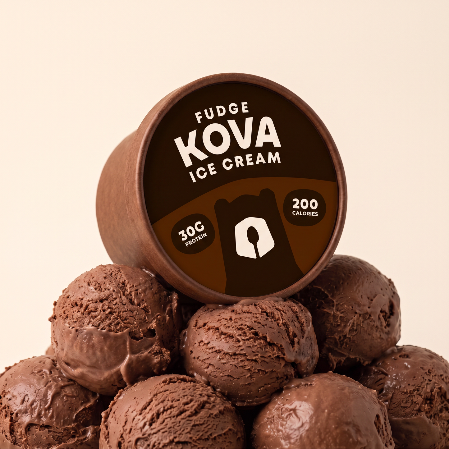 Kova Fudge protein ice cream cup resting on a mountain of chocolate fudge ice cream scoops — 30g protein, 200 calories