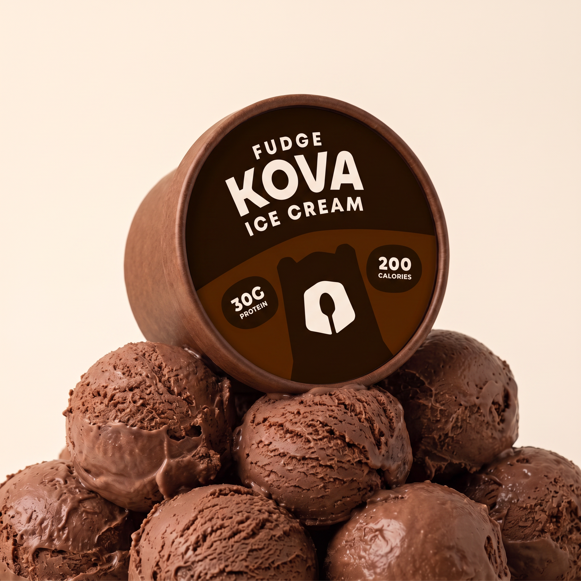 Kova Fudge protein ice cream cup resting on a mountain of chocolate fudge ice cream scoops — 30g protein, 200 calories