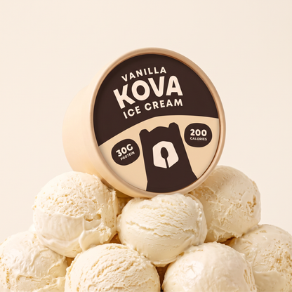 Kova Vanilla protein ice cream cup resting on a mountain of vanilla ice cream scoops — 30g protein, 200 calories