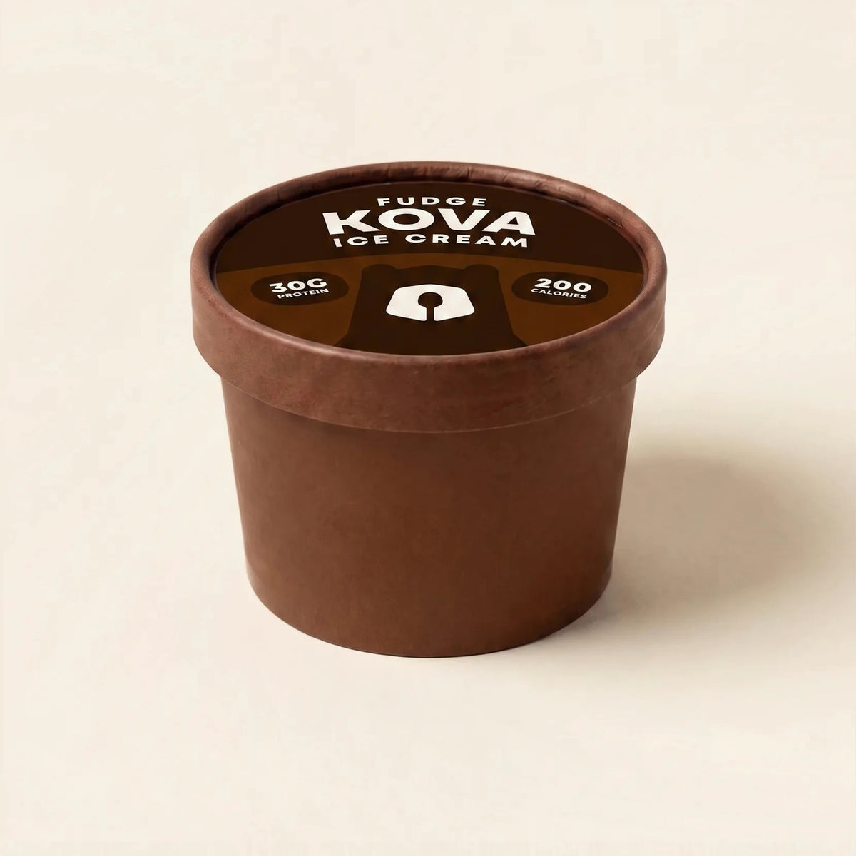 A single-serve cup of Kova Fudge protein ice cream facing forward on a cream background