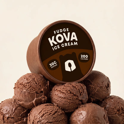 Kova Fudge protein ice cream cup resting on a mountain of chocolate fudge ice cream scoops