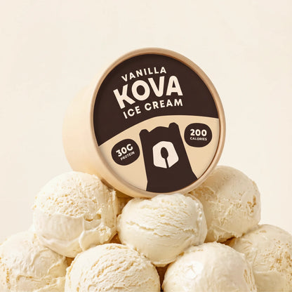 Kova Vanilla protein ice cream cup resting on a mountain of vanilla ice cream scoops