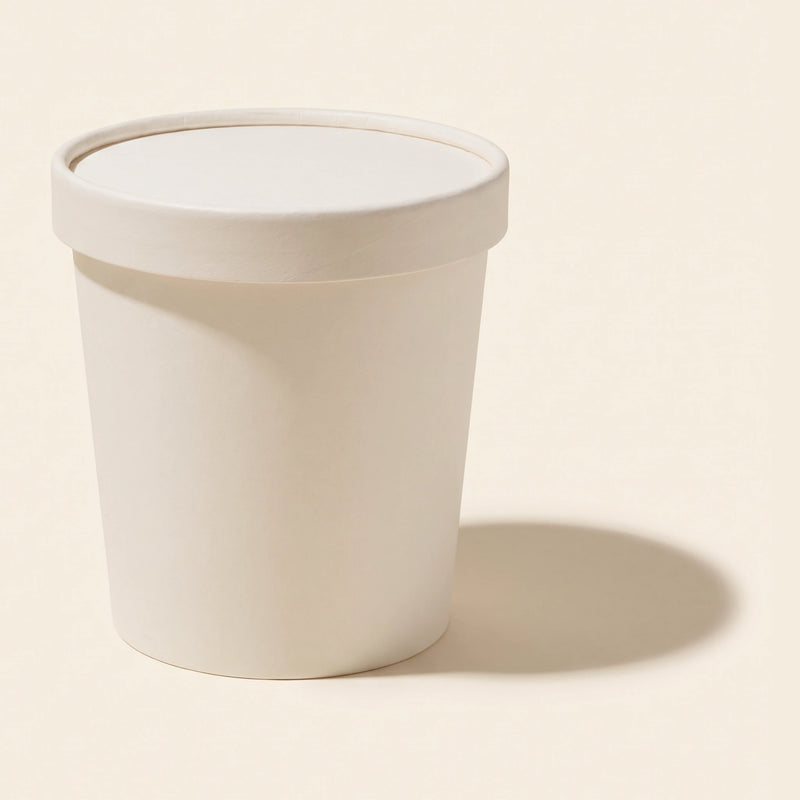 A plain unbranded ice cream pint tub on a cream background